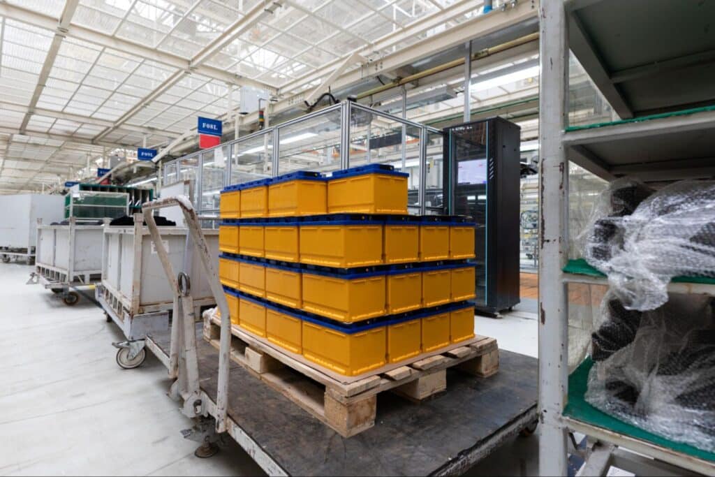 Stacked yellow boxes in a modern warehouse environment on a pallet.
