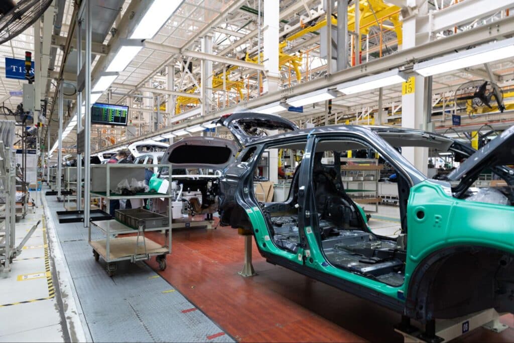 Automobile production line showcasing vehicles under assembly in a modern factory.