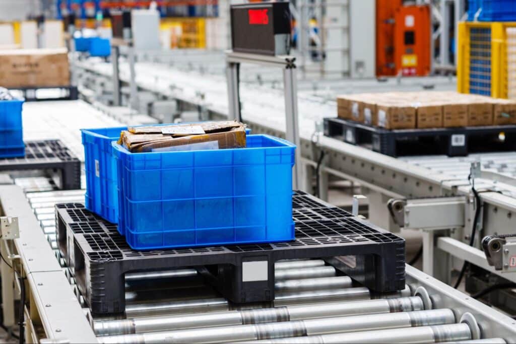 Blue baskets on a conveyor system for efficient material handling.