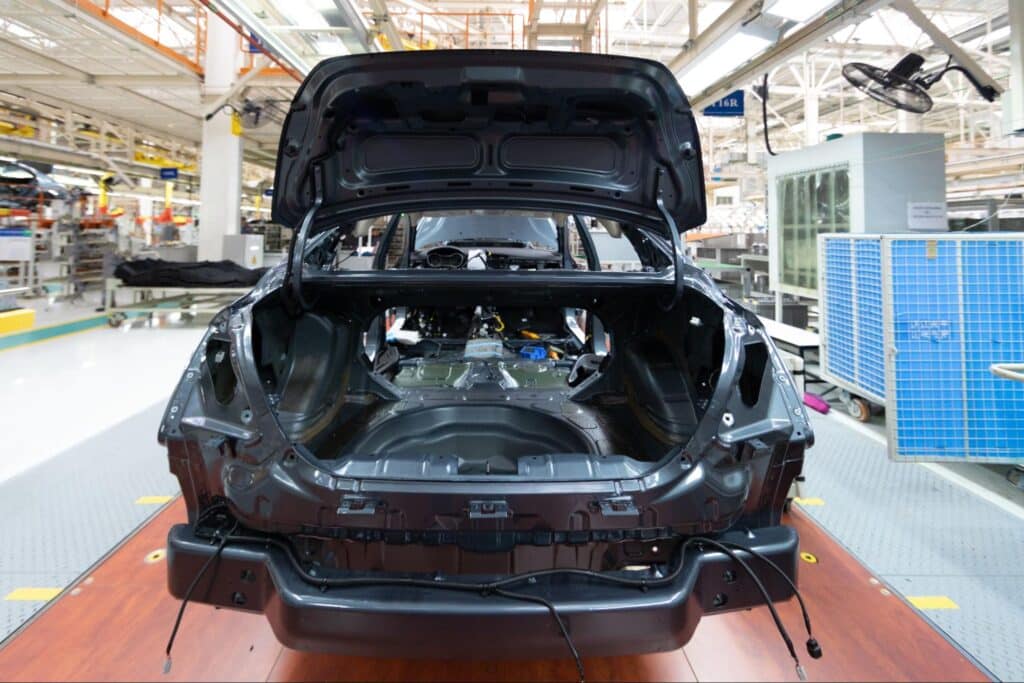 Car assembly line focused on vehicle production and interior preparation.