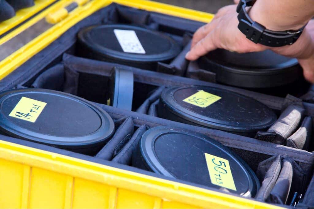 Camera lens organized in a yellow case for quick and easy access.