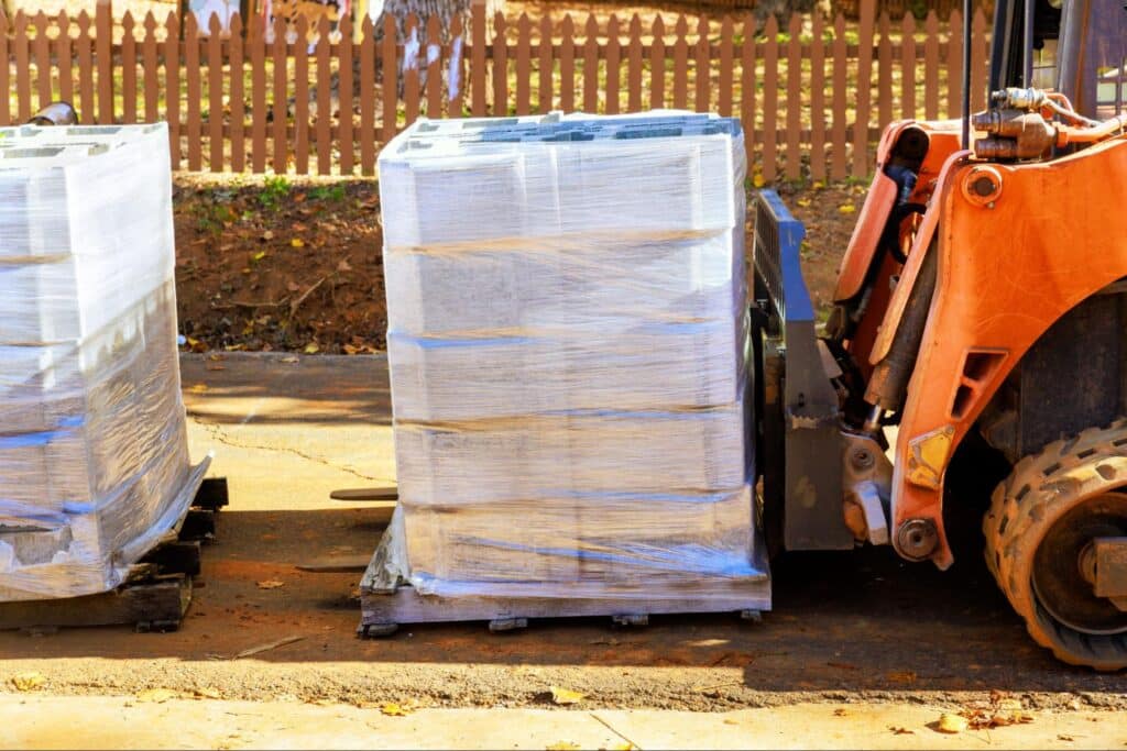 Pallets loaded and ready for shipment with forklift assistance.