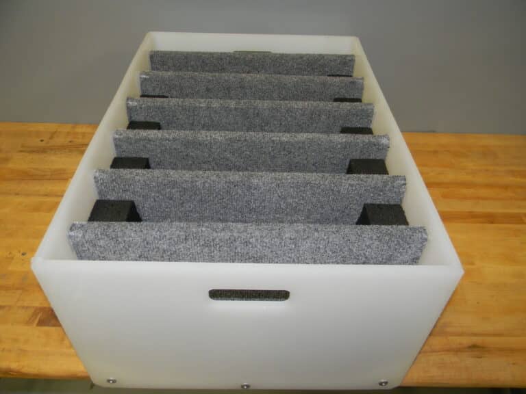 Solid plastic dunnage insert with precision cavities for industrial bins
