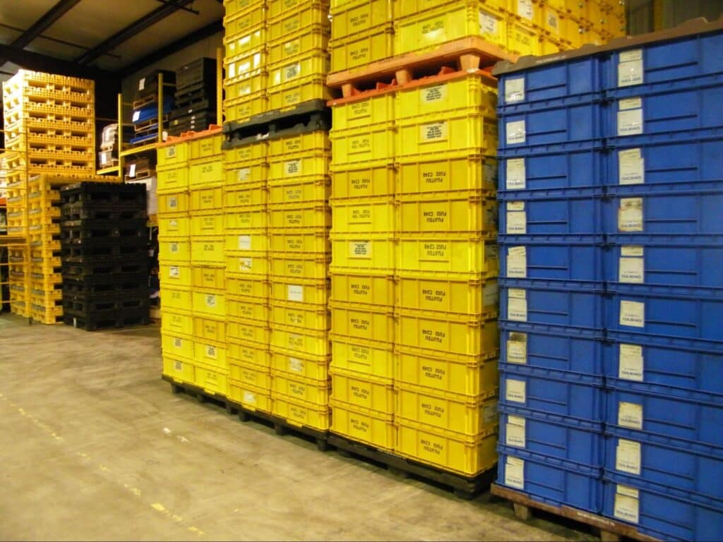 Colorful storage bins organized for improved warehouse efficiency and inventory management.