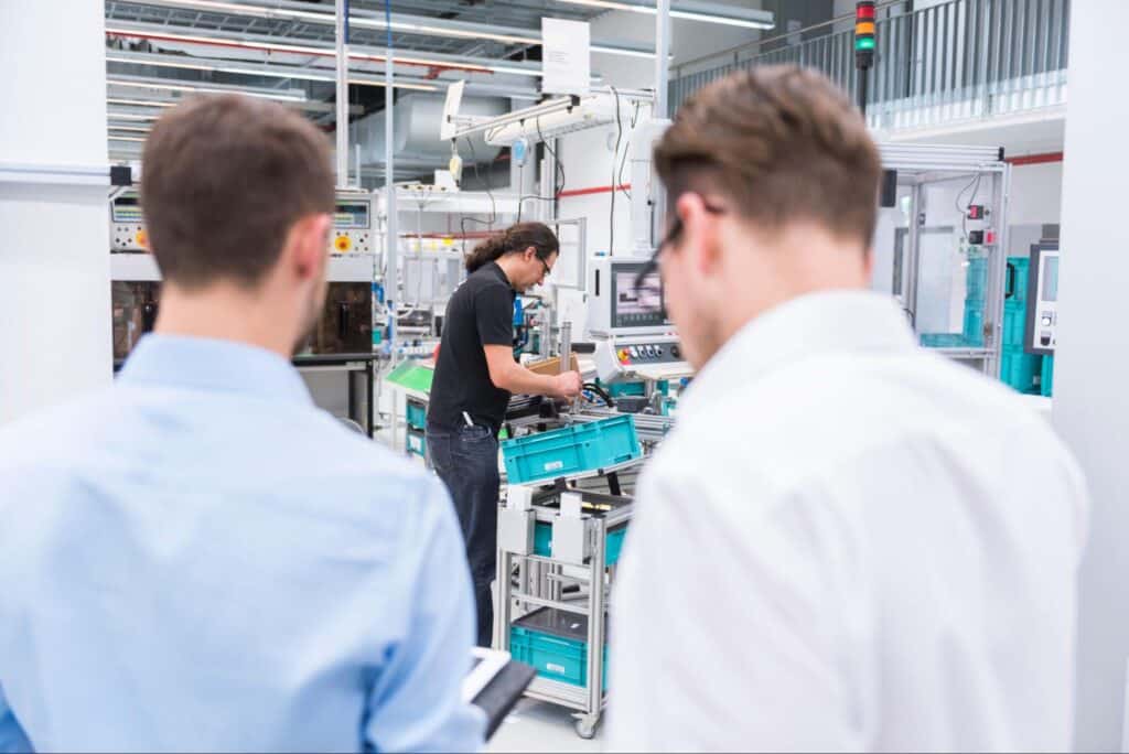 Industry experts evaluate cutting-edge manufacturing technology in a state-of-the-art facility.