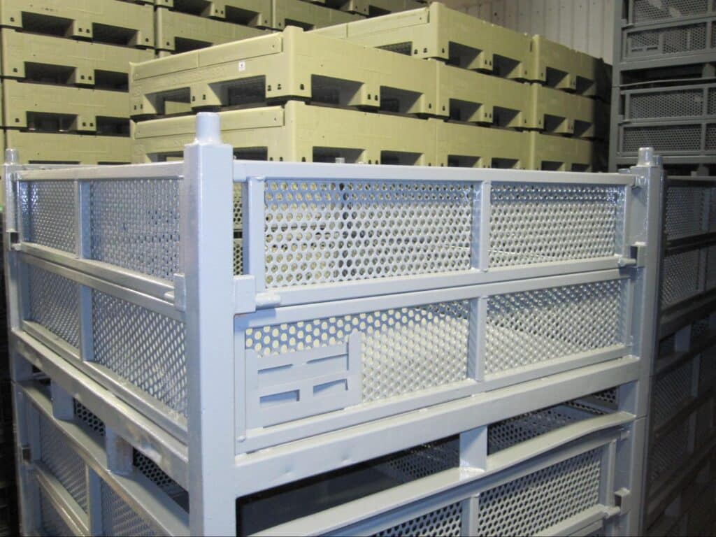 Industrial storage containers stacked for efficient organization and accessibility in a warehouse.
