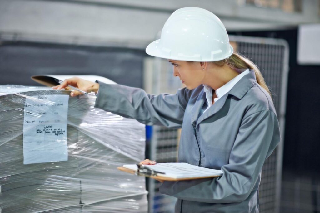 Warehouse worker inspecting inventory accuracy and packaging compliance