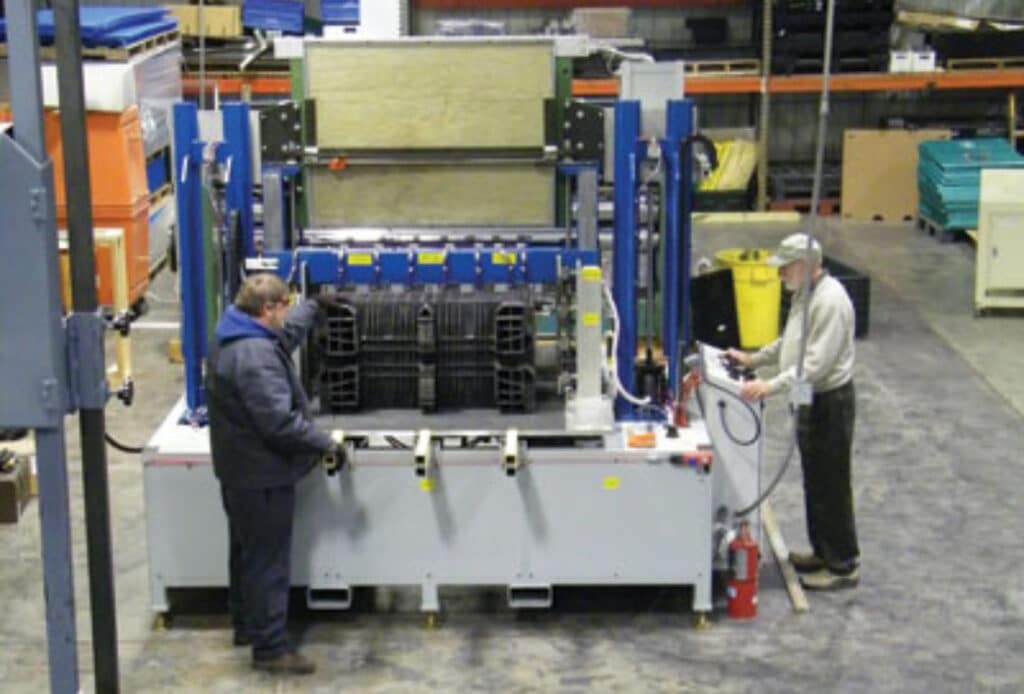 Workers operating industrial machinery in a production facility.