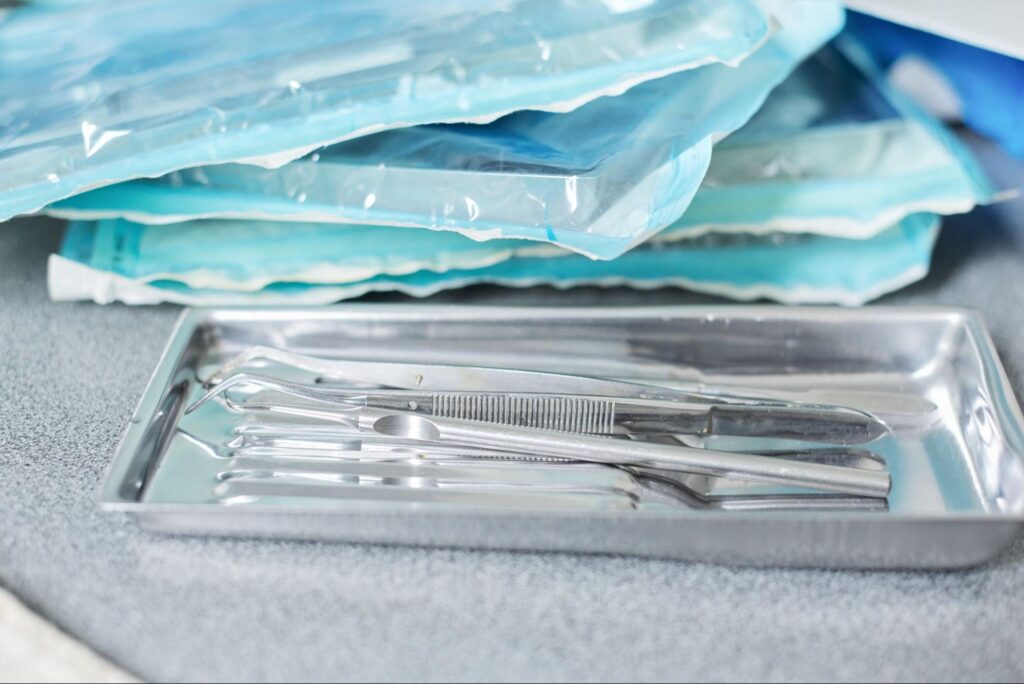 Surgical instruments organized on a tray, prepared for use in medical procedures.