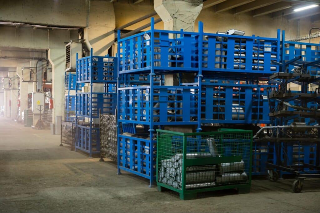 Warehouse interior showcasing blue storage pallets and organized materials for efficient inventory management.