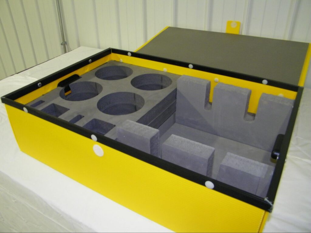 Custom yellow Reusable Dunnage featuring foam inserts for organized equipment protection.