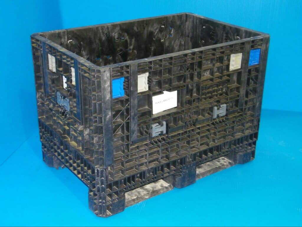 Durable black plastic storage container ideal for warehouse and logistics needs.