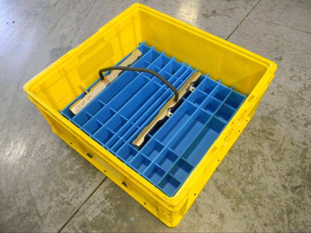 Custom yellow storage bin with blue dividers for efficient tool organization.